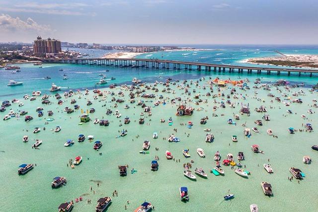 Aerial view of the Destin Bridge and emerald green waters of the East Pass near our family vacation rentals.