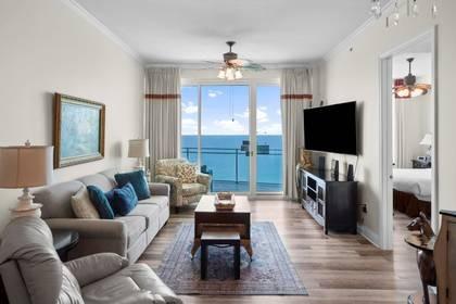Living room with large window and view of the beach