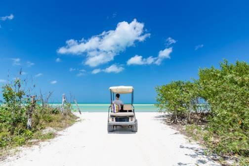Man driving golf cart on the beach