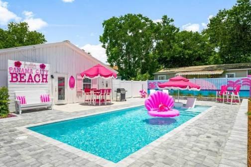 Private pool with pink amenities in the backyard